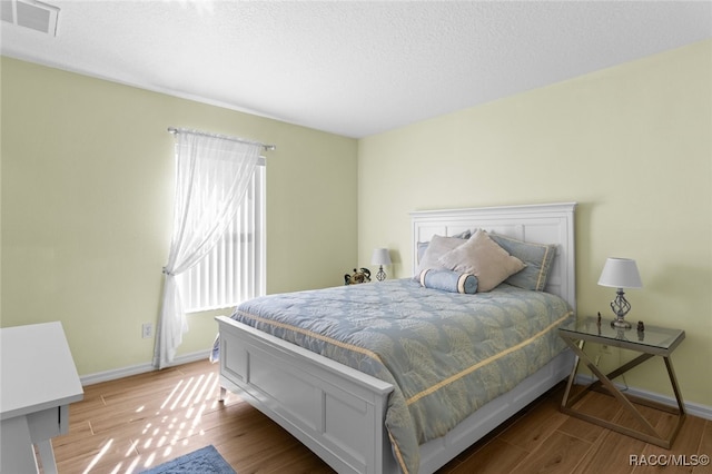 5705 N Bedstrow Blvd, Beverly Hills, FL 34465 - bedroom featuring wood finished floors and a textured ceiling