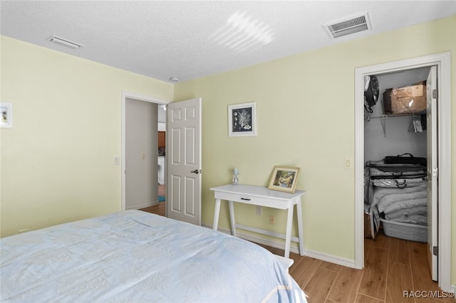 5705 N Bedstrow Blvd, Beverly Hills, FL 34465 - bedroom with wood finished floors, a walk in closet, and a closet
