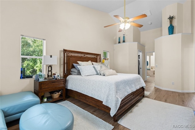 5705 N Bedstrow Blvd, Beverly Hills, FL 34465 - bedroom with high vaulted ceiling, wood finished floors, ensuite bath, and ceiling fan