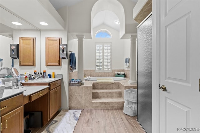 5705 N Bedstrow Blvd, Beverly Hills, FL 34465 - bathroom featuring ornate columns, vanity, a garden tub, and lofted ceiling