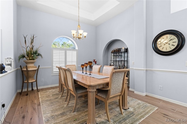 5705 N Bedstrow Blvd, Beverly Hills, FL 34465 - dining space with light wood-type flooring, a chandelier, and a tray ceiling