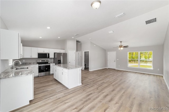 5674 N Claremont Dr, Citrus Springs, FL 34434 - kitchen with light wood-style flooring, appliances with stainless steel finishes, a sink, and a kitchen island