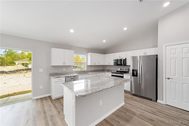 5674 N Claremont Dr, Citrus Springs, FL 34434 - kitchen with light wood-style flooring, stainless steel appliances, a center island, and a sink