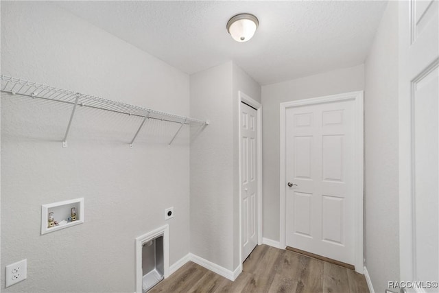 5674 N Claremont Dr, Citrus Springs, FL 34434 - laundry room featuring wood finished floors, laundry area, electric dryer hookup, washer hookup, and baseboards