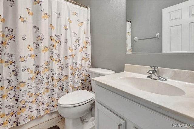 bathroom featuring tile patterned floors, vanity, and toilet