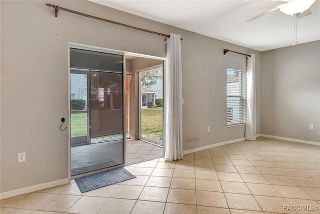 doorway to outside with light tile patterned floors and ceiling fan