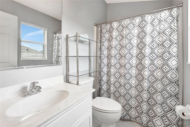 bathroom featuring tile patterned floors, vanity, curtained shower, and toilet