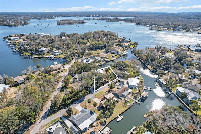 drone / aerial view with a residential view and a water view