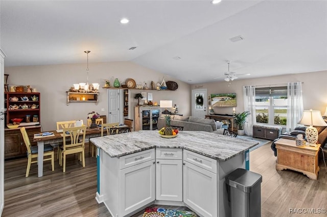 9973 N Chelic Dr, Citrus Springs, FL 34434 - kitchen featuring a ceiling fan, open floor plan, a chandelier, light wood finished floors, and lofted ceiling