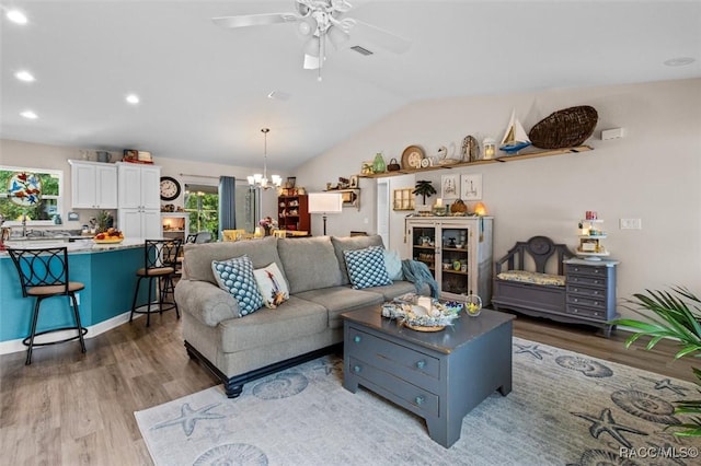 9973 N Chelic Dr, Citrus Springs, FL 34434 - living room with wood finished floors, ceiling fan, a chandelier, vaulted ceiling, and recessed lighting