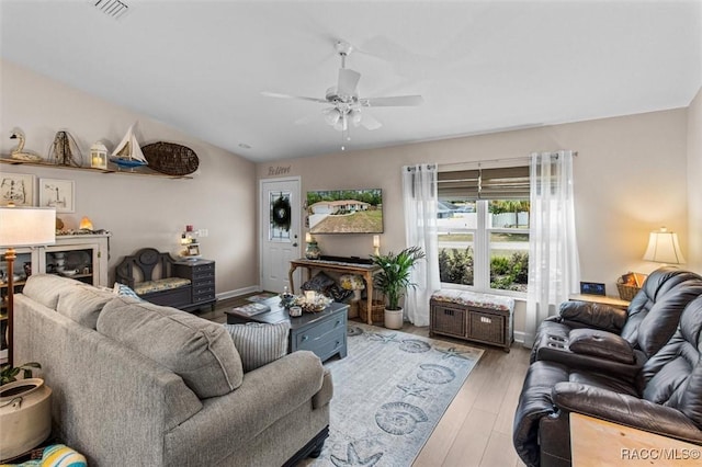 9973 N Chelic Dr, Citrus Springs, FL 34434 - living room featuring a ceiling fan, wood finished floors, baseboards, and lofted ceiling