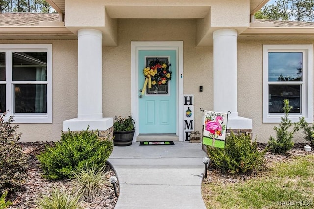 9973 N Chelic Dr, Citrus Springs, FL 34434 - entrance to property featuring stucco siding and a shingled roof