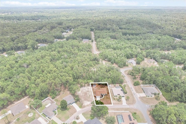 9973 N Chelic Dr, Citrus Springs, FL 34434 - aerial view of property and surrounding area featuring a heavily wooded area and property boundaries highlighted