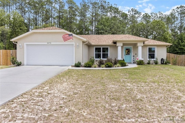 9973 N Chelic Dr, Citrus Springs, FL 34434 - view of front of house featuring an attached garage, concrete driveway, stucco siding, and view of wooded area