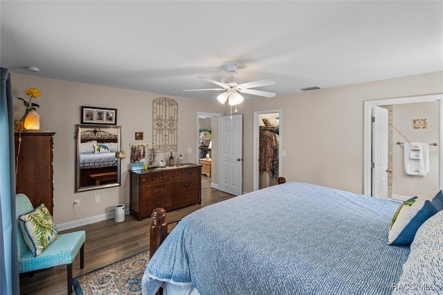 9973 N Chelic Dr, Citrus Springs, FL 34434 - bedroom with dark wood-style flooring, baseboards, a walk in closet, ceiling fan, and a closet