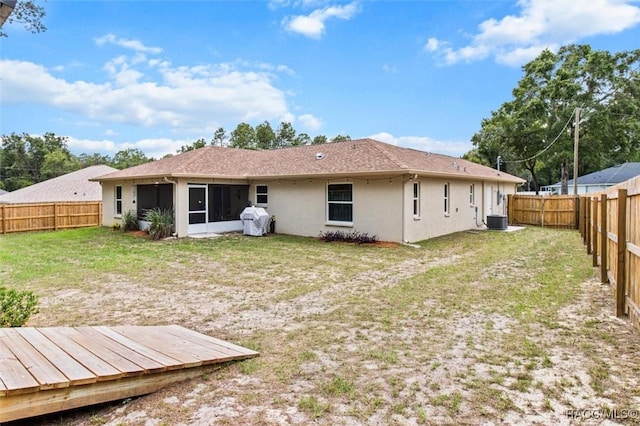 9973 N Chelic Dr, Citrus Springs, FL 34434 - back of property with central AC, stucco siding, and a sunroom
