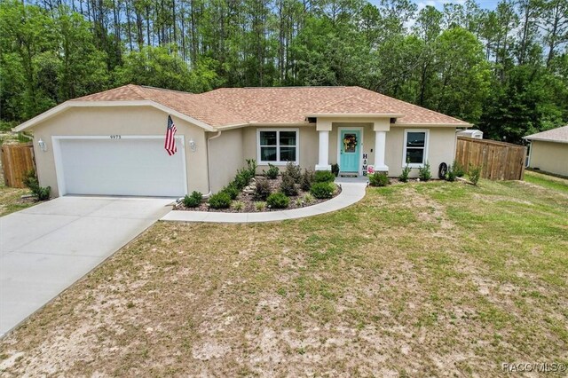9973 N Chelic Dr, Citrus Springs, FL 34434 - ranch-style house with an attached garage, stucco siding, concrete driveway, and a shingled roof