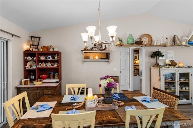 9973 N Chelic Dr, Citrus Springs, FL 34434 - dining room featuring lofted ceiling, wood finished floors, and a chandelier