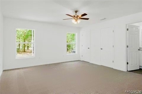 unfurnished bedroom featuring carpet flooring and ceiling fan