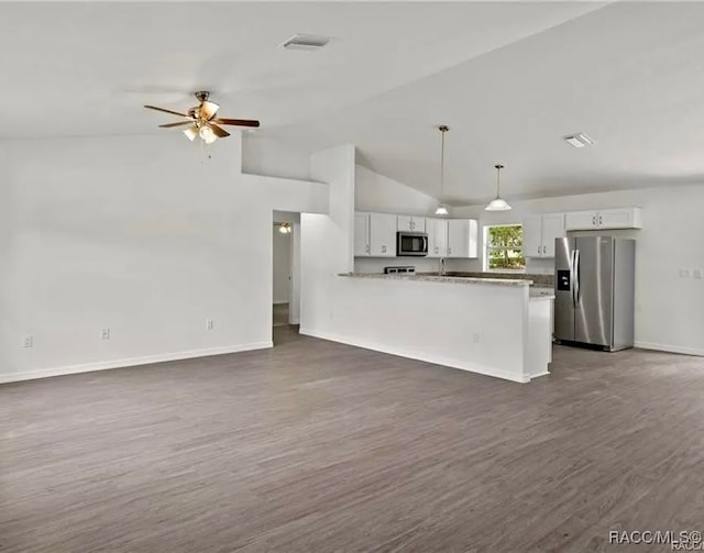 kitchen with dark hardwood / wood-style floors, kitchen peninsula, decorative light fixtures, white cabinets, and appliances with stainless steel finishes