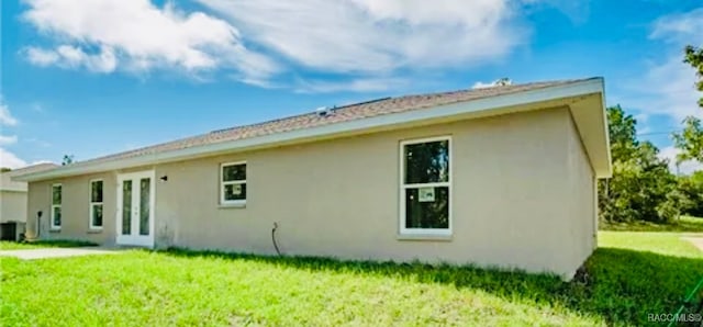 rear view of property featuring a yard