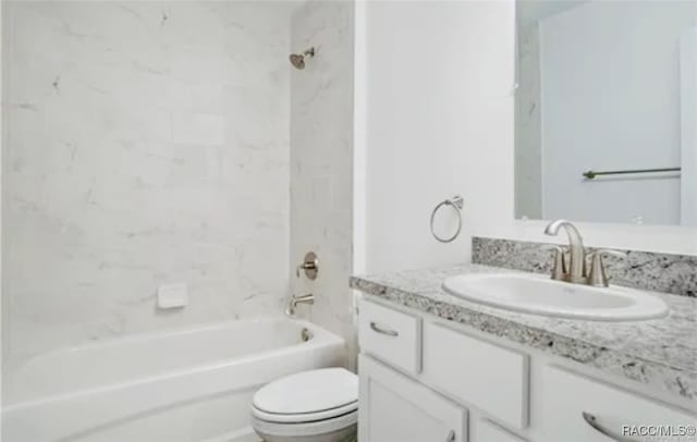 full bathroom with vanity, tiled shower / bath combo, and toilet