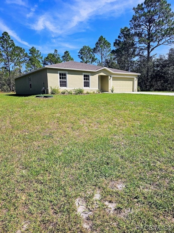 single story home featuring a garage and a front lawn