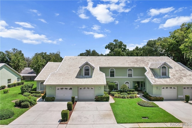 view of front of house with a front yard and a garage