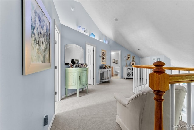 sitting room with light colored carpet and lofted ceiling