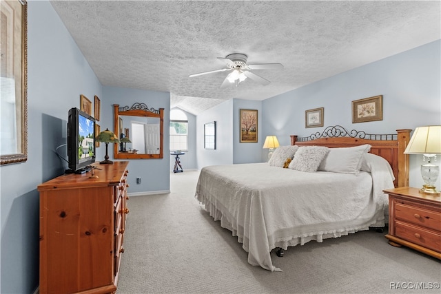 carpeted bedroom with ceiling fan and a textured ceiling