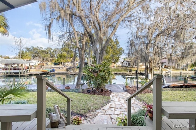 dock area with a yard and a water view