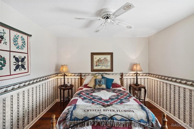 bedroom with dark hardwood / wood-style floors and ceiling fan