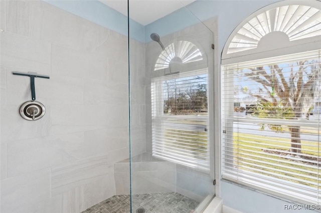 bathroom with a tile shower