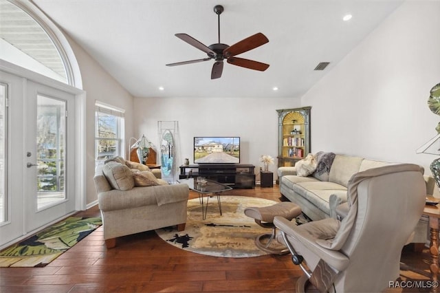 living room featuring lofted ceiling, dark hardwood / wood-style flooring, and ceiling fan