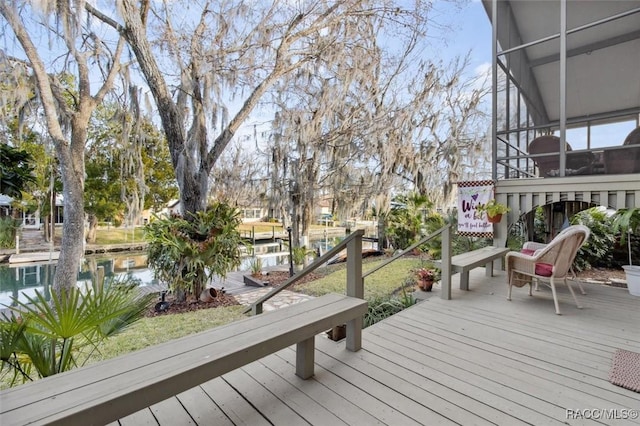 wooden terrace featuring a water view