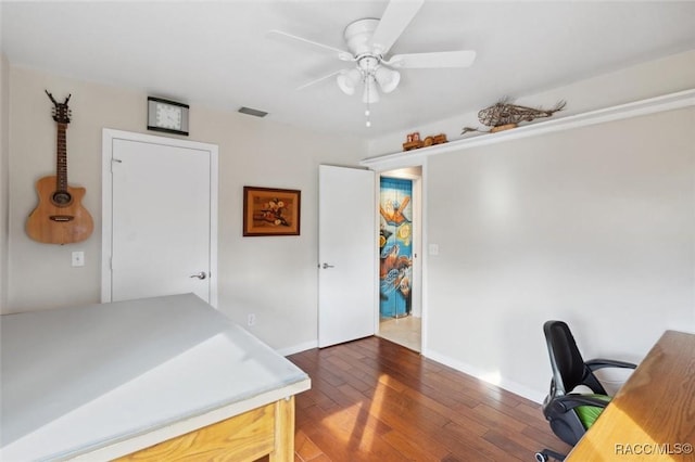 office area featuring dark wood-type flooring and ceiling fan