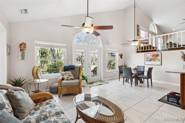 tiled living room featuring high vaulted ceiling, french doors, and ceiling fan