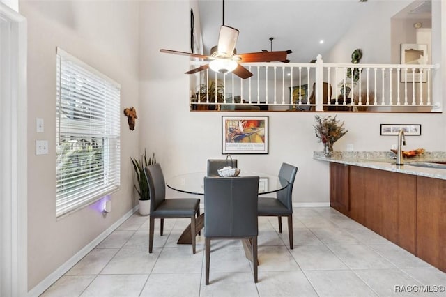 dining area featuring sink, ceiling fan, and light tile patterned flooring