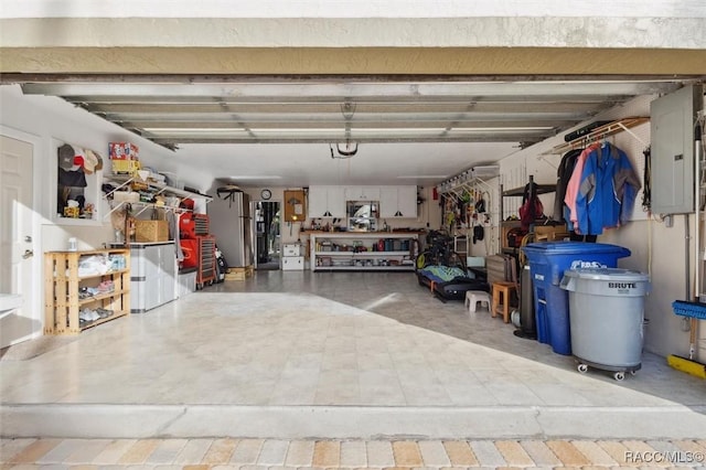 garage with electric panel and a workshop area