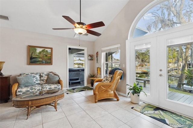 sunroom featuring lofted ceiling, ceiling fan, and french doors