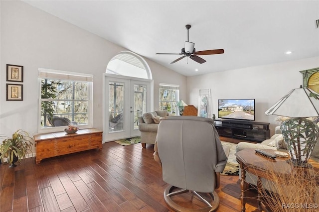 living room with plenty of natural light, dark hardwood / wood-style floors, lofted ceiling, and french doors