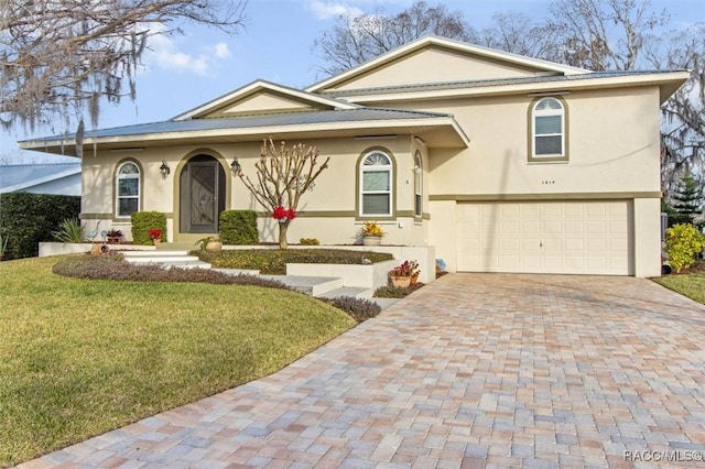 view of front facade with a garage and a front lawn