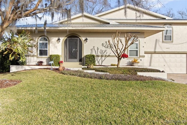 view of front of home featuring a garage and a front lawn