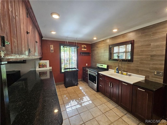 kitchen featuring crown molding, sink, pendant lighting, stainless steel range with gas cooktop, and light tile patterned flooring