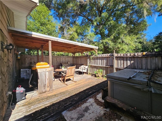 wooden deck featuring a hot tub