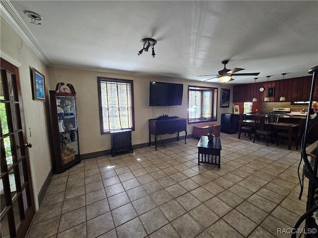 tiled living room with ceiling fan and ornamental molding