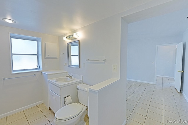 bathroom featuring tile patterned flooring, plenty of natural light, toilet, and vanity