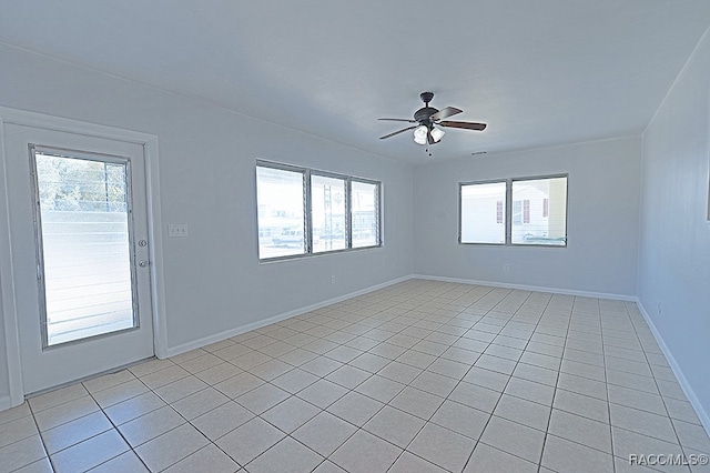 spare room featuring ceiling fan and light tile patterned floors