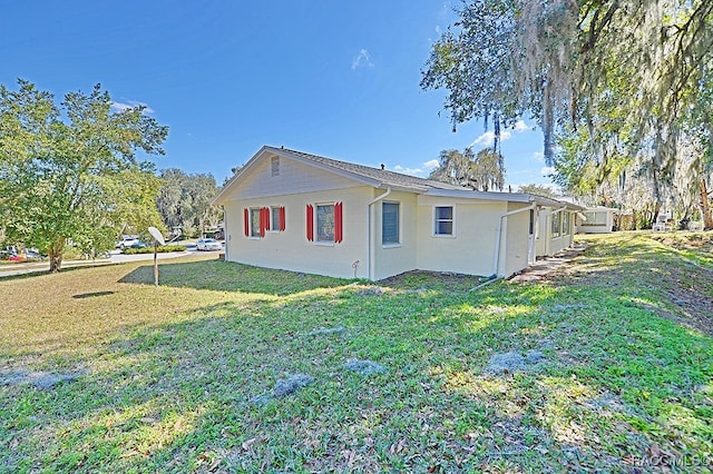 view of side of home featuring a lawn