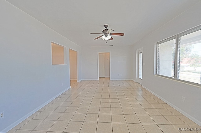 tiled spare room featuring ceiling fan